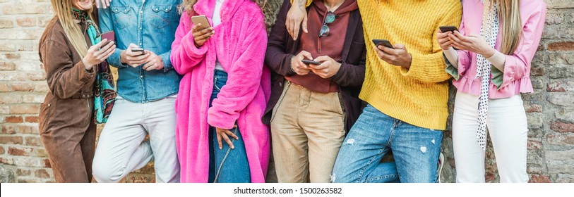 Trendy influencers friends using smartphones  - Millennials generation addiction to new technology trends - Concept of youth, commute, tech, social and friendship - Focus on hands