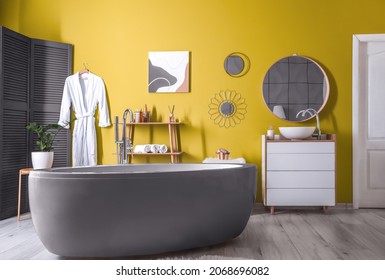 Trendy Interior Of Bathroom With Yellow Wall