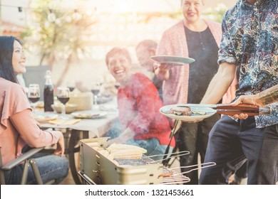 Trendy Man Cooking And Serving Meat At Barbecue Dinner Outdoor - Chef Grilling Food For Family Friends At Bbq Meal Outside - Summer Lifestyle, Friendship And Fun Concept - Focus On Hand Tongs