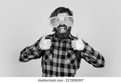 trendy man in funny party glasses. funny and joyful man wear checkered shirt. just having fun. happy brutal party goer. mature bearded hipster in good mood. fashion concept. thumb up - Shutterstock ID 2172090397