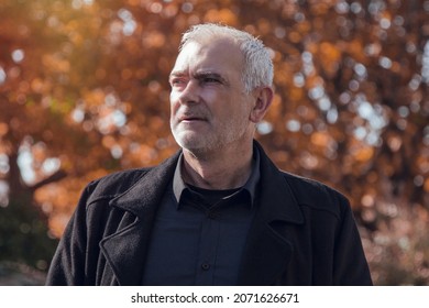 Trendy Man In A Warm Overcoat Posing Outdoors