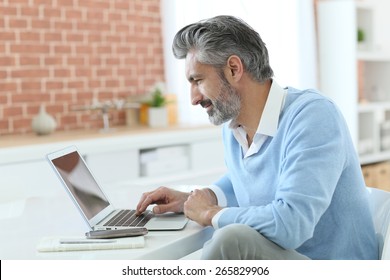 Trendy Mature Man Working From Home With Laptop