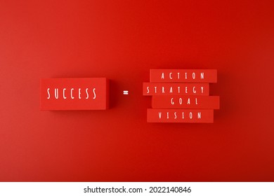 Trendy minimal success formula or business development concept in red colors. Vision, goal, strategy, action written on blocks against red background. 