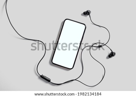 Trendy Mobile Phone Application Mockup with Headphones