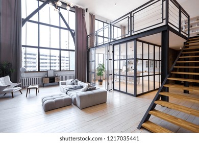 trendy modern design two-level 
apartment with large high windows. The stylish living room and kitchen in bright colors are undressed by a glass partition. bedroom on the second floor. - Shutterstock ID 1217035441
