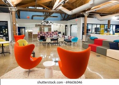 Trendy modern open concept loft office space with big windows, natural light and a layout to encourage collaboration, creativity and innovation