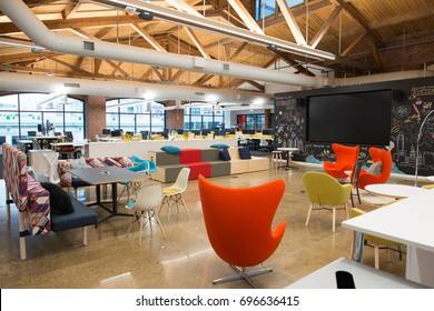 Trendy modern open concept loft office space with big windows, natural light and a layout to encourage collaboration, creativity and innovation - Shutterstock ID 696636415