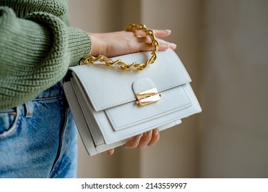 Trendy outfit woman with black bag. Girl with bag over his shoulder outdoors. Shoulder Bags for Women. Fashion look woman outfit. Stylish women's beige handbag. Close-up. - Shutterstock ID 2143559997