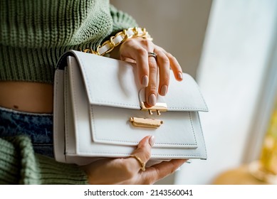 Trendy outfit woman with black bag. Girl with bag over his shoulder outdoors. Shoulder Bags for Women. Fashion look woman outfit. Stylish women's beige handbag. Close-up. - Powered by Shutterstock