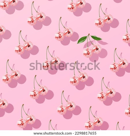 Trendy pattern composition made with Decorative disco balls like cherries on pastel pink background. Concept of minimal entertainment. Flat lai. Contemporary style. Creative art, minimal aesthetics.
