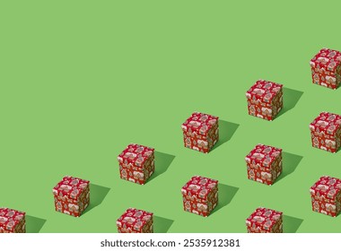 Trendy pattern composition made with red Christmas gift box on light green background with copy space. Minimal creative Christmas and New Year concept. Festive holiday pattern backdrop.