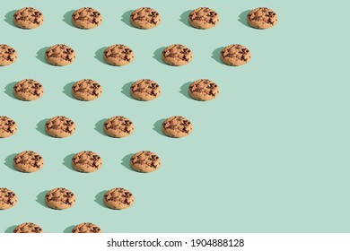 Trendy pattern made  of chocolate chip cookies on bright green mint background. Minimal concept, diagonal copy space. - Shutterstock ID 1904888128