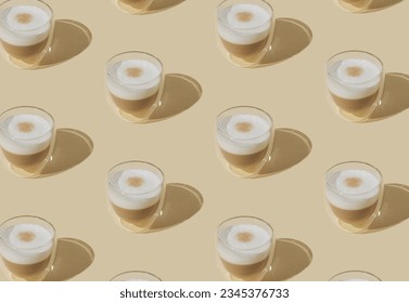 Trendy pattern made of cup of coffee on pastel cream background. Creative coffee concept. Minimal latte macchiato pattern idea. Coffee aesthetic.