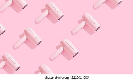 Trendy Pattern Made Of Hair Dryer On Sunny Pink Background With Diagonal Copy Space. Creative Hairdressers Wallpaper.