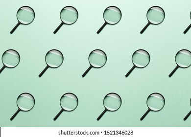 Trendy pattern made with Magnifying glass on bright light mint background. Concept information search. Minimal style with colorful paper backdrop. Colorful photo. Minimal creative concept. Neo mint