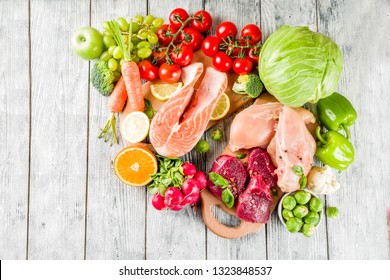 Trendy Pegan Diet - Vegan Plus Paleo Diet Food Concept, Many Fresh Vegetables, Fruits, Raw Beef And Chicken Meat, Salmon Fish, White Wooden Background Top View Copy Space