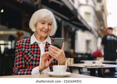 Trendy Pensioner Female Enjoying Coffee Break Outdoors