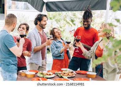 trendy people around the table in a daylight walking dinner party cheering and having fun