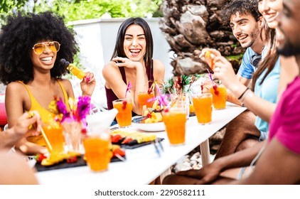 Trendy people drinking fancy cocktails at poolside garden party - Young friends having fun on luxury resort - Life style concept with men and women toasting drinks together - Bright vivid filter - Powered by Shutterstock