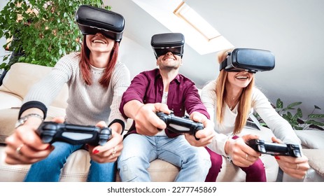 Trendy people playing with vr glasses at shared apartment - Virtual reality and wearable tech concept with happy friends having fun with headset goggle - Generation z digital trends - Focus on mid guy - Powered by Shutterstock