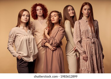 Trendy Red-haired Models. Elegant Ladies In Dress In Fasionable Outfit Isolated On Beige Background. Beauty, Style, Models, People Concept