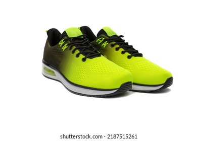 Trendy Sports Shoes, With A Black And Yellow Color Gradient, And White Soles, Isolated On White Background.