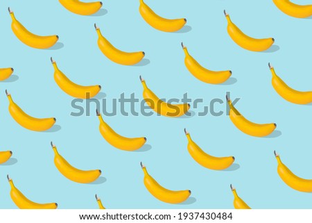 Trendy Summer food pattern made with fresh banana fruit on bright blue background. Minimal summer concept.