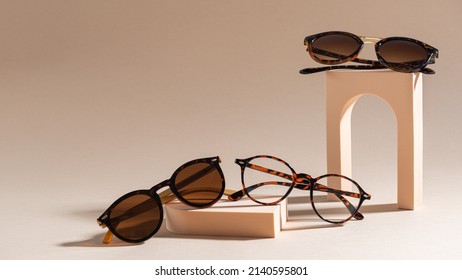 Trendy sunglasses of different design and eyeglasses on a beige background. Copy space. Sunglasses and spectacles sale concept. Optic shop promotion banner. Eyewear fashion. Minimalism - Shutterstock ID 2140595801