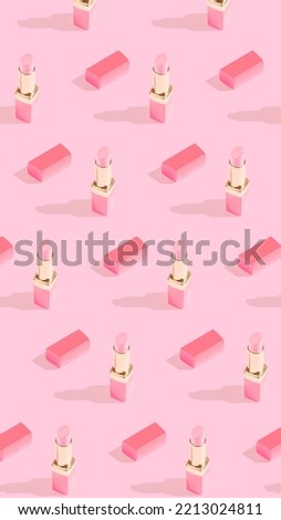 Trendy vertical crop pattern with shiny lipstick on bright pink background. Makeup studio concept.