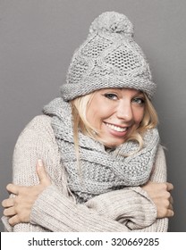 Trendy Warm Winter - Beautiful Young Blond Woman Trying To Stay Warm In Wrapping Up Herself In Gray Wool Winter Hat And Scarf For Comfort And Cozy Temperature