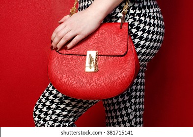 Trendy Woman In Pants With Red Leather Bag . Stylish Outfit And Fashion Concept