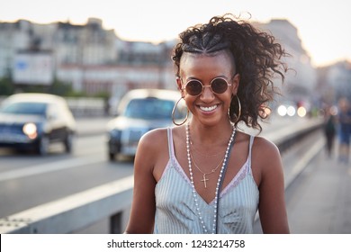 Trendy woman in striped camisole and sunglasses, portrait