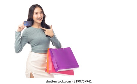 Trendy Young Asian Woman Hold Plastic Credit Card And Shopping Bags Pointing Up To Credit Card Beautiful Shopping Girl Point To Credit Card With Smile Looking At Camera Isolated On White Background