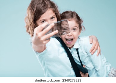 Trendy young girls in business attire snap selfies, mindful of their online appearance and reputation with cutting-edge phones - Powered by Shutterstock