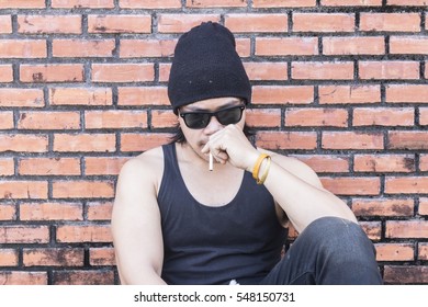 Trendy young man smoking outdoors - Powered by Shutterstock