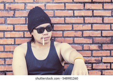 Trendy young man smoking outdoors - Powered by Shutterstock