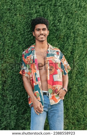 Trendy young man wearing unbuttoned stylish shirt [[stock_photo]] © 