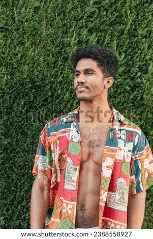 Trendy young man wearing unbuttoned stylish shirt [[stock_photo]] © 