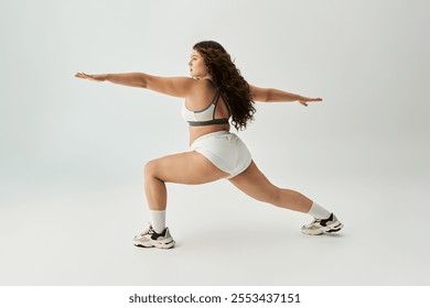 Trendy young plus size woman confidently showcases stylish underwear in a dynamic pose. - Powered by Shutterstock