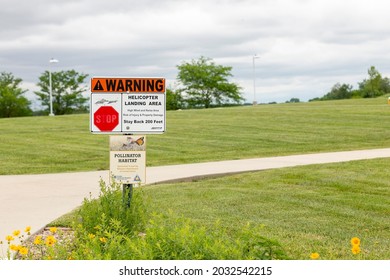 Trenton, Missouri United States Of America - May 28th, 2021 : Warning Sign For Helicopter Landing Area, Near Med Flight Helicopter Pad. Sign For Pollinator Habitat Underneath.
