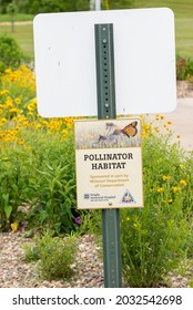Trenton, Missouri United States Of America - May 28th, 2021 : Sign For Pollinator Habitat, With Flowers And Vegetation In Background.  Vertical View Informational Sign.