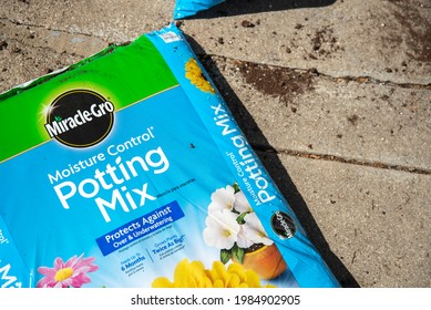 Trenton, MO United States Of America - May 29th, 2021: Opened Bag Of Miracle-Gro Moisture Control Potting Mix On Concrete Patio.  Potting Soil Packaging Close Up, Summer Diy Concept.