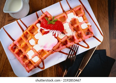 Tres Leches Belgian Waffles With Dulce De Leche, Carmel Drizzle And Strawberry Garnish.