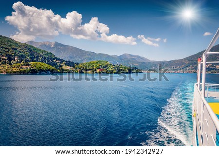 Treveling by ferry from Lefkada island to Kefalonia. Spectacular morning seascape of Ionian Sea. Colorful spring view of Nydri town, Greece, Europe. Traveling concept background.
