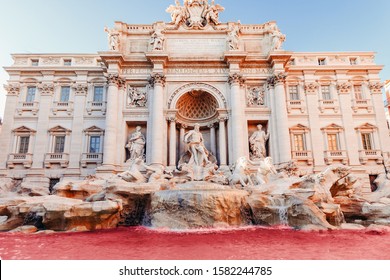 Trevi Fountain red water sunset baroque architecture and landmark Rome Italy.
