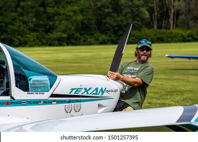 Treviso, Italy - 07/2017: Man Pulling The Texan Top Class Touristic Airplane To The Runway.