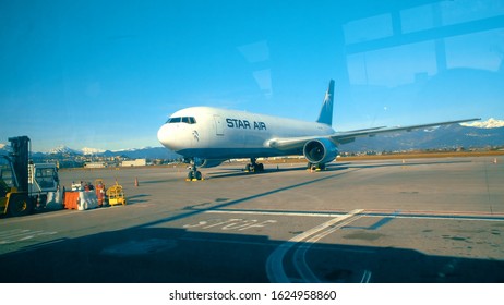 Treviso, Italy - circa Jan, 2018: Passenger POV from transportation bus at airport runaway to parked planes and cargo transportation vehicles, visible wind reflections - Shutterstock ID 1624958860