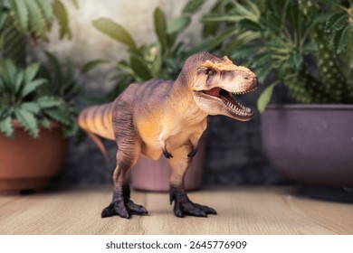 T-rex Dinosaur toy. Tyrannosaurus rex with Dorstenia Plant in plastic pot simulate the atmosphere of the ancient era on wooden table. - Powered by Shutterstock - Get 15% off with code: PIKWIZARD15