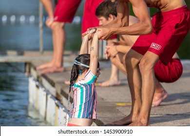 Tri Harder Kids Triathlon, Horseshoe Lake, Succasunna, NJ 07/16/2019  Lifeguard Assists A Young Swimmer As She Exits The Water