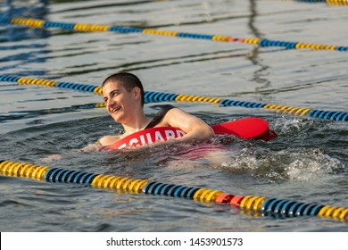 Tri Harder Kids Triathlon, Horseshoe Lake, Succasunna, NJ 07/16/2019  A Lifeguard Treads Awaiting The Start Of The Race